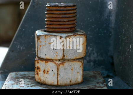 A large rusted bolt with screw. Part of a huge metal construction. Stock Photo