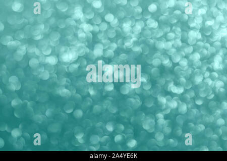 Christmas background. Abstract shiny mint color background. Bokeh and sparkles. Selective focus, bokeh. Stock Photo