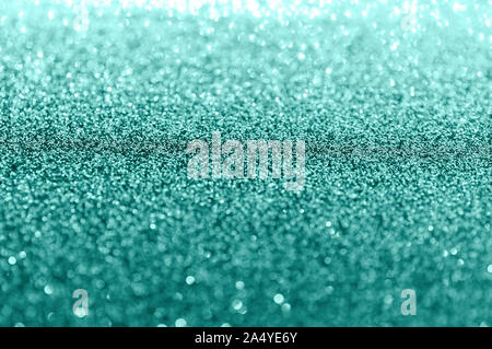 Christmas background. Abstract shiny mint color background. Bokeh and sparkles. Selective focus, bokeh. Stock Photo