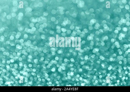 Christmas background. Abstract shiny mint color background. Bokeh and sparkles. Selective focus, bokeh. Stock Photo