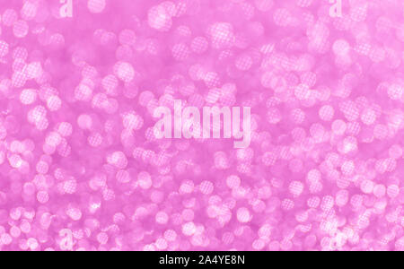 Christmas background. Pink abstract shiny background with bokeh and sparkles. Selective focus, bokeh. Stock Photo