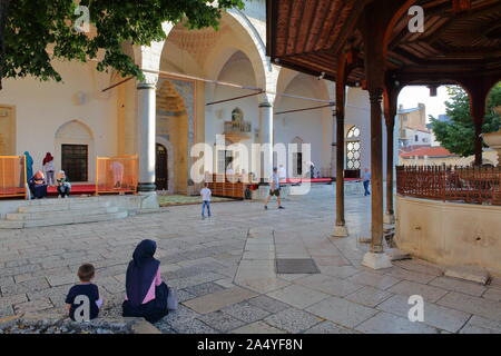 SARAJEVO, BOSNIA AND HERZEGOVINA - SEPTEMBER 15, 2019: The internal courtyard of Gazi Husrev Begova Mosque, with people praying Stock Photo