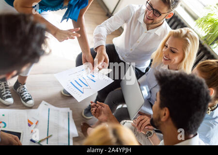 Happy creative team in office. Business, startup, design, people and teamwork concept Stock Photo