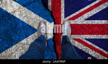 Business man stands on cracked flag of UK and Scotland. Political concept Stock Photo