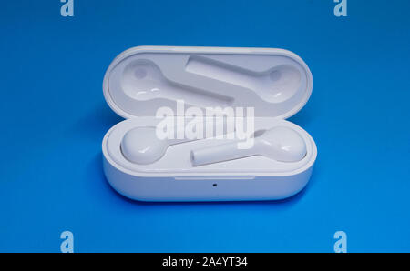 Wireless Bluetooth Earphone or Ear bud. Air Pods wireless Bluetooth headphones. Stock Photo