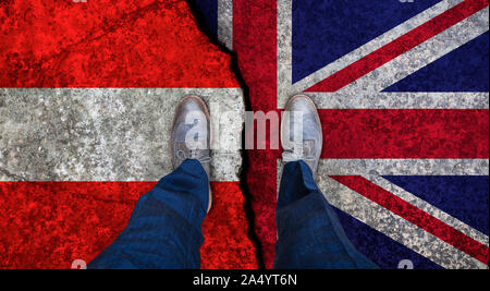 Business man stands on cracked flag of UK and Austria. Political concept Stock Photo