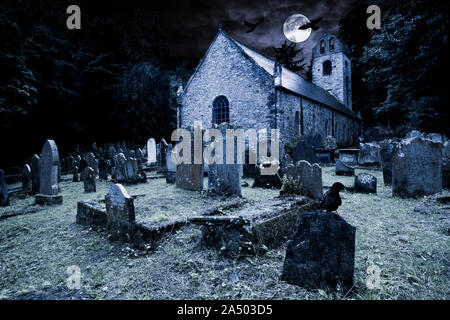 old graveyard with ancient tombstones grave stone and old church in front of full moon black raven dark night spooky horror background Stock Photo