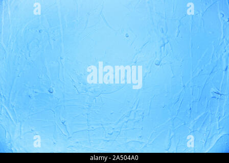 Soft paint drops on wall, bright blue colors palette Stock Photo