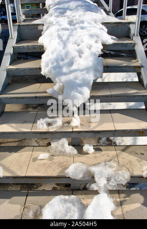 Gray stairs covered with white snow, close up detail Stock Photo