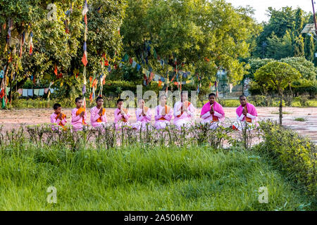 Young Buddhist Monk praying and meditating at Lumbini, Nepal Stock Photo