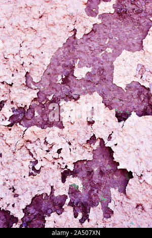 Cracked soft pink paint surface with rusty dark brown details close up, grunge vertical shabby background Stock Photo