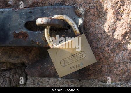 Close up view of an old padlock on a wooden door Stock Photo