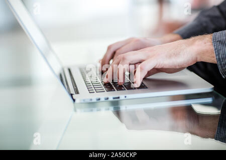 Work on a laptop - as always, the programmer pretends to work Stock Photo