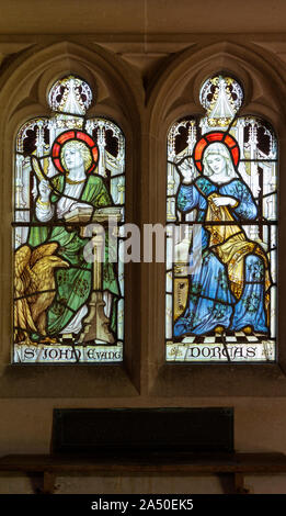 Stained glass window of Saint John the Evangelist and Dorcas, Seend church, Wiltshire, England, 1905 UK  James Powell and Sons Stock Photo