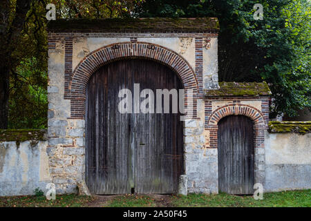 Large and small castle doors entrance  in rural France Stock Photo