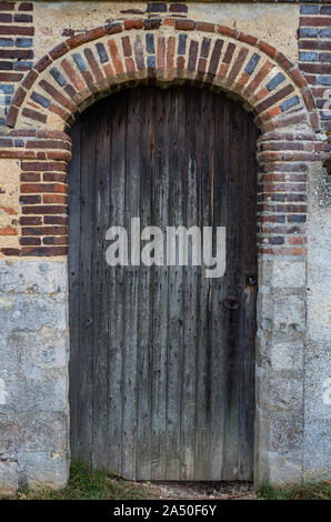 Close up detail on side entrance wooden door of old castle in rural France Stock Photo