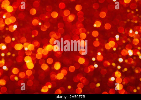 Orange and red festive background with sparkles in the bokeh. The concept of the celebration, the day of St. Valentine, New Year, birthdays, ceremonies, events, etc. Stock Photo