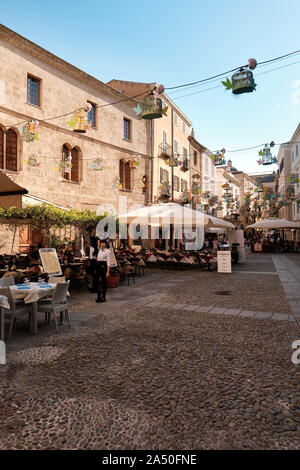 Restaurants and the cobblestoned streets of Alghero on the northwest coast of Sardinia, encircled by ancient walls - Sardinia Italy Europe Stock Photo