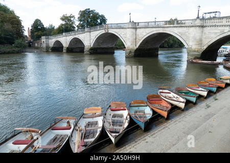 Richmond Bridge across the River Thames in the summer, with rowing boats in the foreground Stock Photo