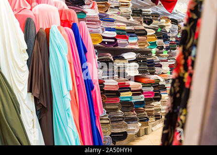 Rolls of fabric and textiles in a factory shop. Multi different colors and patterns on the market Fabrics in rolls. Stock Photo