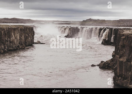 Dramatic view of Selfoss waterfall in cold and gray autumn weather. Amazing nordic landscape. Popular Icelandic tourist landmark. Stock Photo