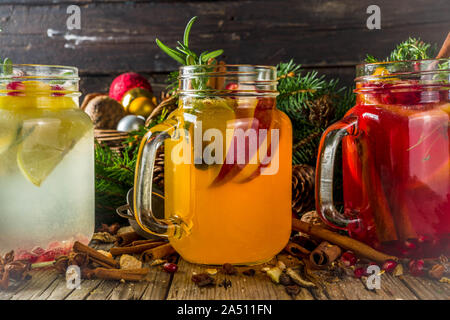 Autumn winter sangria, mulled wine or hot spiced cider cocktails. Red, white and orange hot winter drinks and beverages, in glass mason jar mugs with Stock Photo