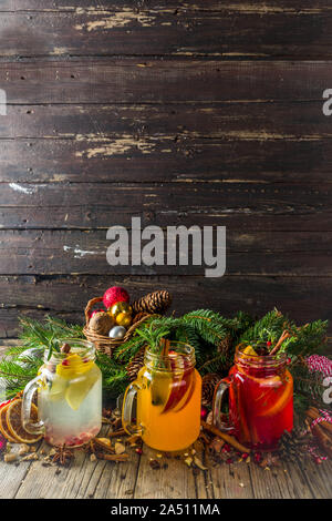 Autumn winter sangria, mulled wine or hot spiced cider cocktails. Red, white and orange hot winter drinks and beverages, in glass mason jar mugs with Stock Photo