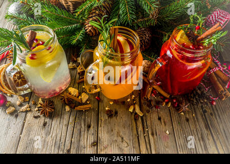 Autumn winter sangria, mulled wine or hot spiced cider cocktails. Red, white and orange hot winter drinks and beverages, in glass mason jar mugs with Stock Photo