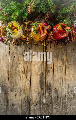Autumn winter sangria, mulled wine or hot spiced cider cocktails. Red, white and orange hot winter drinks and beverages, in glass mason jar mugs with Stock Photo