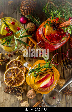 Autumn winter sangria, mulled wine or hot spiced cider cocktails. Red, white and orange hot winter drinks and beverages, in glass mason jar mugs with Stock Photo