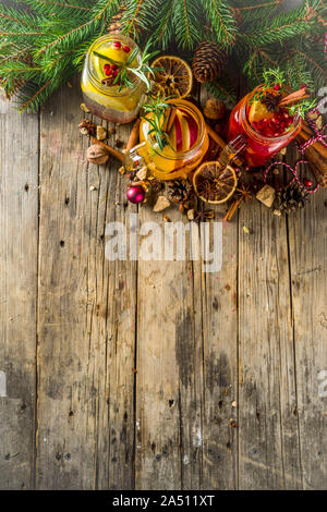 Autumn winter sangria, mulled wine or hot spiced cider cocktails. Red, white and orange hot winter drinks and beverages, in glass mason jar mugs with Stock Photo
