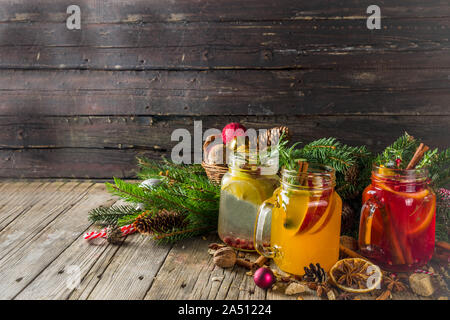 Autumn winter sangria, mulled wine or hot spiced cider cocktails. Red, white and orange hot winter drinks and beverages, in glass mason jar mugs with Stock Photo