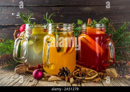 Autumn winter sangria, mulled wine or hot spiced cider cocktails. Red, white and orange hot winter drinks and beverages, in glass mason jar mugs with Stock Photo