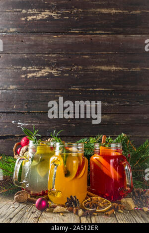 Autumn winter sangria, mulled wine or hot spiced cider cocktails. Red, white and orange hot winter drinks and beverages, in glass mason jar mugs with Stock Photo