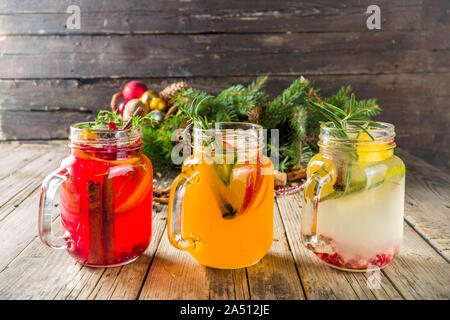 Autumn winter sangria, mulled wine or hot spiced cider cocktails. Red, white and orange hot winter drinks and beverages, in glass mason jar mugs with Stock Photo