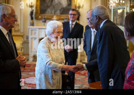 Queen Elizabeth II talks with Sir Trevor McDonald, a trustee of The Queen's Trust, during a reception at Buckingham Palace in London to mark the work of the charity. PA Photo. Picture date: Thursday October 17, 2019. See PA story ROYAL Queen . Photo credit should read: Victoria Jones/PA Wire Stock Photo