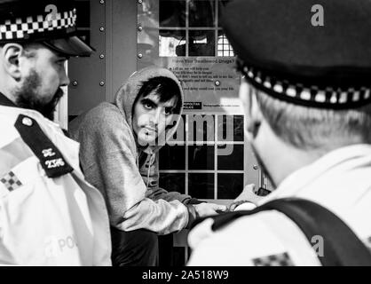 Arrested Extinction Rebellion Protester in back of police van during climate protests London October 2019 Stock Photo
