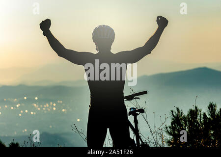 Success, achievement, accomplishment and winning concept with male mountain biker Stock Photo