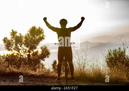 Success, achievement, accomplishment and winning concept with male mountain biker Stock Photo