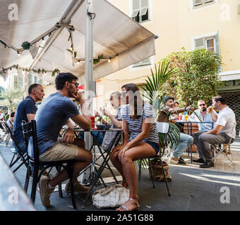 People drinking and talking in a cafe , Nice, France Stock Photo