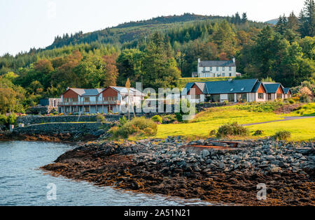 Cottages facing Loch Linnhe in Corran, a village on the west side of the Corran Narrows of the Loch Linnhe, in the Scottish Highlands. Stock Photo