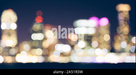 Color toned blurred city lights at night, urban abstract background. Stock Photo