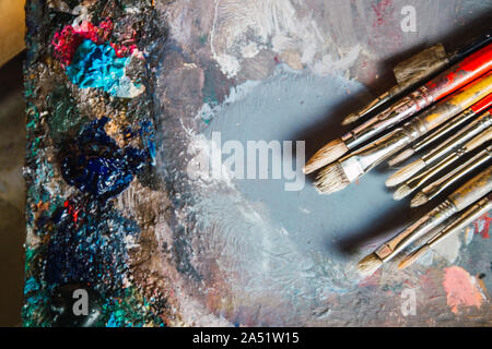 used and very stained color palette of various uses with various brush Stock Photo