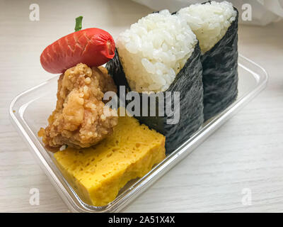 Japanese fast food, two sushi rolls, a mini sausage, egg and chicken Stock Photo