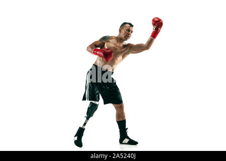 Full length portrait of muscular sportsman with prosthetic leg, copy space. Male boxer in red gloves. Isolated shot on white studio background. Stock Photo