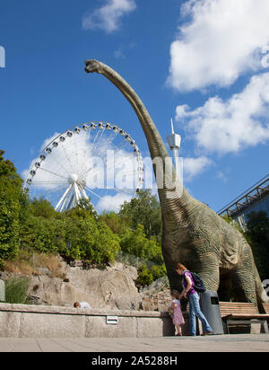 In the foreground a dinosaur outside the Universeum and in the background the Liseberg wheel (formerly the Gothenburg Wheel), which is a Ferris wheel at Liseberg in Gothenburg.Photo Jeppe Gustafsson Stock Photo