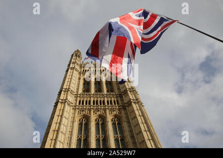 Westminster, London, UK, 17 Oct 2019. A Union Jack flag in front of the Elizabeth Tower at Houses of Parliament. Pro- and anti-Brexit protests continue around the Houses of Parliament in Westminster with flags, banners and other equipment carrying slogans. Credit: Imageplotter/Alamy Live News Stock Photo