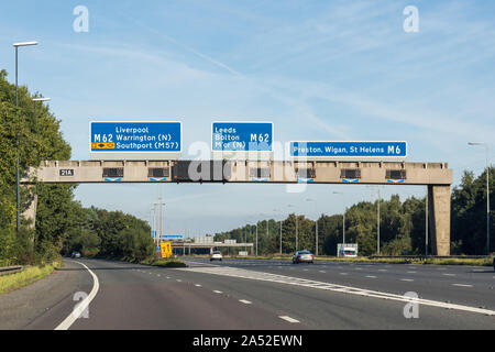 UK motorway sign showing directions to M62 Liverpool, Warrington, Southport (M57), M 62 Leeds, Bolton, Manchester and M6 Preston, Wigan, St Helens, UK Stock Photo