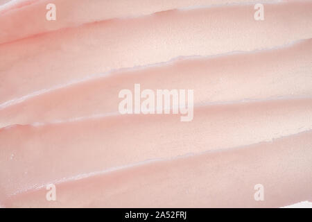 Delicate pink texture and strokes of a cosmetic face mask or cream on a white background Stock Photo