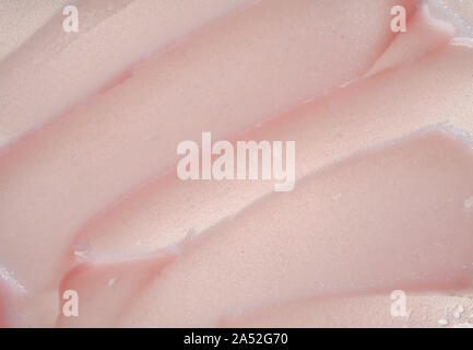Delicate pink texture and strokes of a cosmetic face mask or cream on a white background Stock Photo